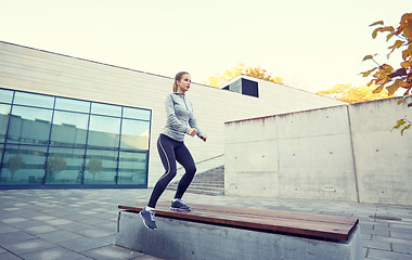 Image showing woman exercising on bench outdoors