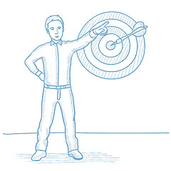 Image showing Businessman pointing at arrow in target board.