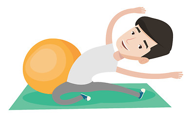 Image showing Young man exercising with fitball.