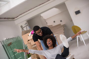 Image showing African American couple  playing with packing material