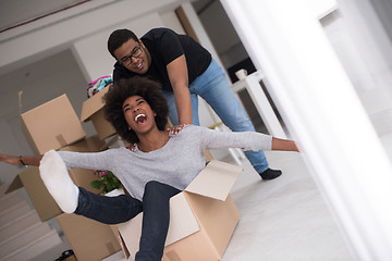 Image showing African American couple  playing with packing material