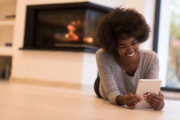 Image showing black women used tablet computer on the floor