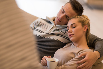 Image showing Young couple  in front of fireplace