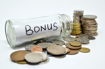 Image showing Bonus lable in a glass jar with coins spilling out