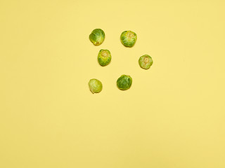 Image showing The piles of Brussels sprouts on a yellow background