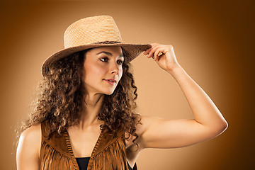 Image showing The cowgirl fashion woman over a brown background