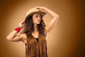 Image showing The cowgirl fashion woman over a brown background