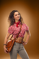 Image showing The cowgirl fashion woman over a brown background