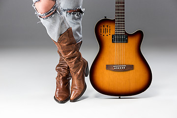 Image showing Legs in Jeans and Cowboys Boots