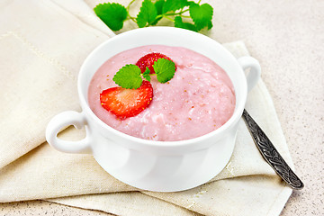 Image showing Soup strawberry in white bowl on stone table