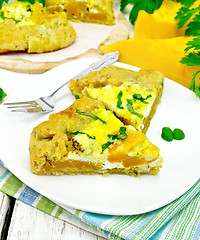 Image showing Pie of pumpkin and basil in plate on towel