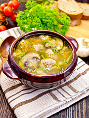 Image showing Soup with meatballs and mushrooms in brown bowl on board
