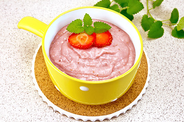 Image showing Soup strawberry in yellow bowl on granite table