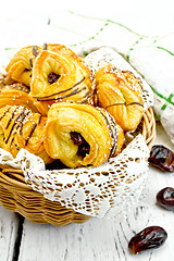 Image showing Cookies with dates in wicker basket on board