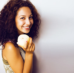 Image showing pretty young real tenage girl eating apple close up smiling