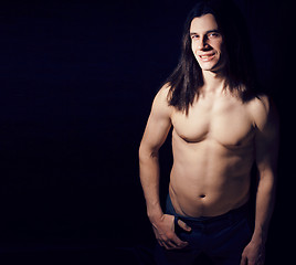 Image showing handsome young man with long hair naked torso on black backgroun