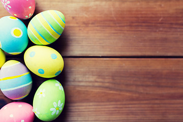 Image showing close up of colored easter eggs on wooden surface