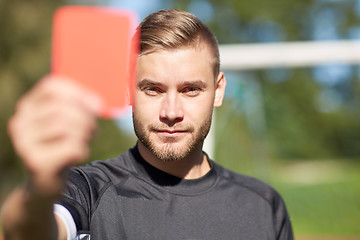 Image showing referee on football field showing red card