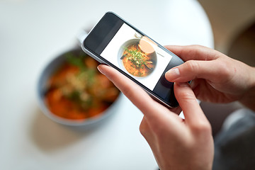 Image showing woman with smartphone photographing food at cafe