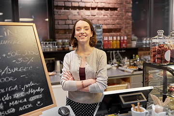 Image showing happy woman or barmaid at cafe counter