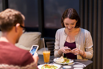 Image showing happy couple having dinner at vegan restaurant