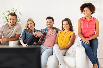 Image showing happy friends with remote watching tv at home