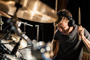 Image showing male musician playing drums and cymbals at concert