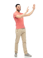 Image showing happy man touching something imaginary