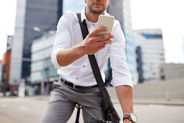 Image showing man with smartphone and fixed gear bike on street