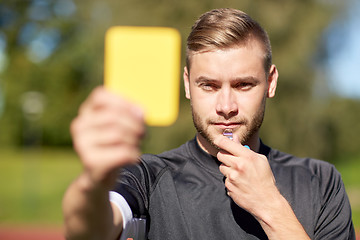 Image showing referee on football field showing yellow card