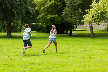 Image showing group of happy kids or friends playing outdoors