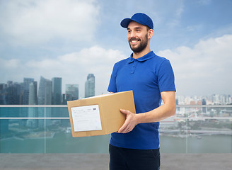 Image showing happy delivery man with box over singapore city