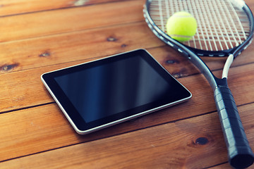 Image showing close up of tennis racket with ball and tablet pc