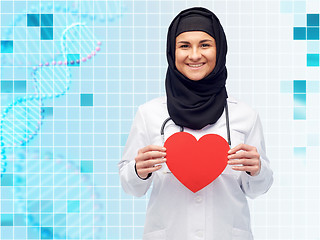 Image showing muslim female doctor in hijab holding red heart
