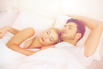 Image showing happy couple sleeping in bed at home