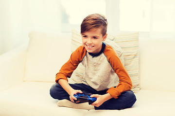 Image showing happy boy with joystick playing video game at home