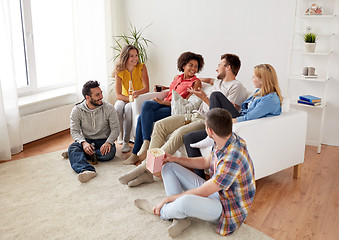 Image showing happy friends with popcorn and beer at home