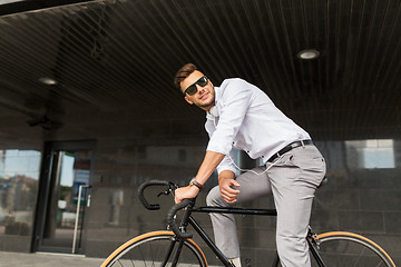 Image showing man with bicycle and headphones on city street