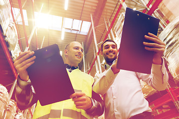 Image showing worker and businessmen with clipboard at warehouse