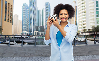 Image showing happy african american woman with film camera