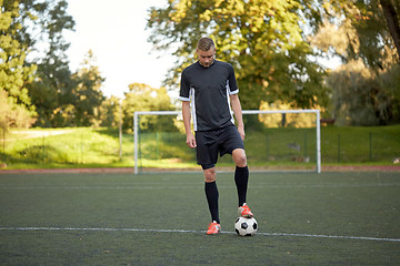 Image showing soccer player playing with ball on football field