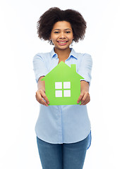 Image showing happy african american woman with green house icon