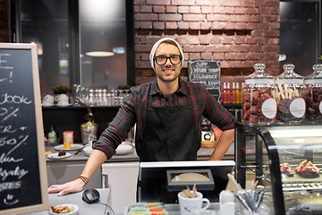 Image showing happy seller man or barman at cafe counter