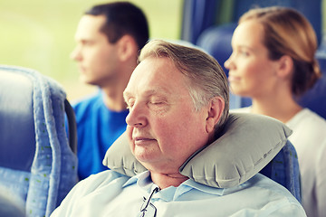 Image showing senior man sleeping in travel bus with neck pillow