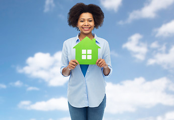 Image showing happy african american woman with green house icon