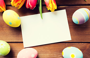 Image showing close up of easter eggs, flowers and white paper