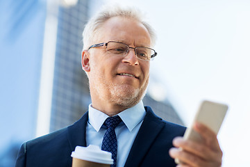 Image showing businessman with smartphone and coffee in city