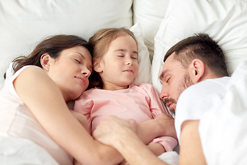 Image showing happy family sleeping in bed at home