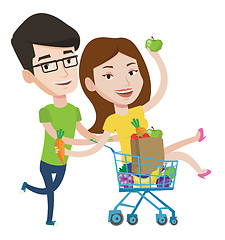 Image showing Couple of friends riding in shopping trolley.