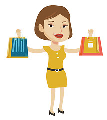 Image showing Happy woman holding shopping bags.